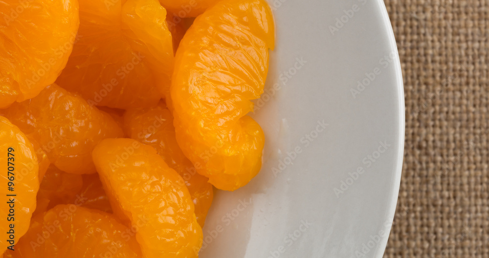 Canned mandarin oranges on a plate top close view Canned mandarin oranges on a plate top close view