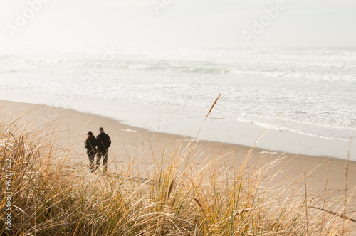 Misty Morning Stroll on a Sandy Beach. Copy space. 