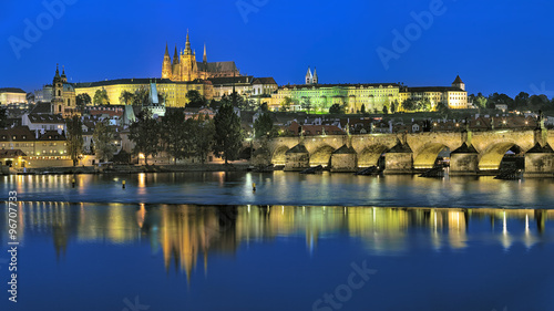 Prague, Czech Republic. Evening view of the Prague Castle with St. Vitus Cathedral, Castle district, Mala Strana district with St. Nicholas Church, and Charles Bridge with Mala Strana Bridge Towers.