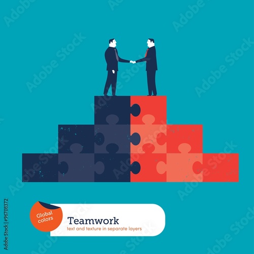 Businessmen shaking hands on a puzzle pyramid.