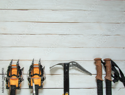 Climbing gear on white wooden background, top view
