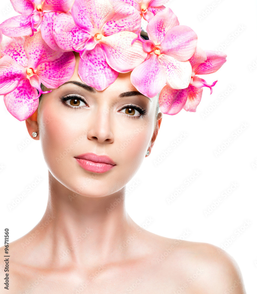 Beautiful face of woman with healthy skin and pink flowers Beautiful face of woman with healthy skin and pink flowers