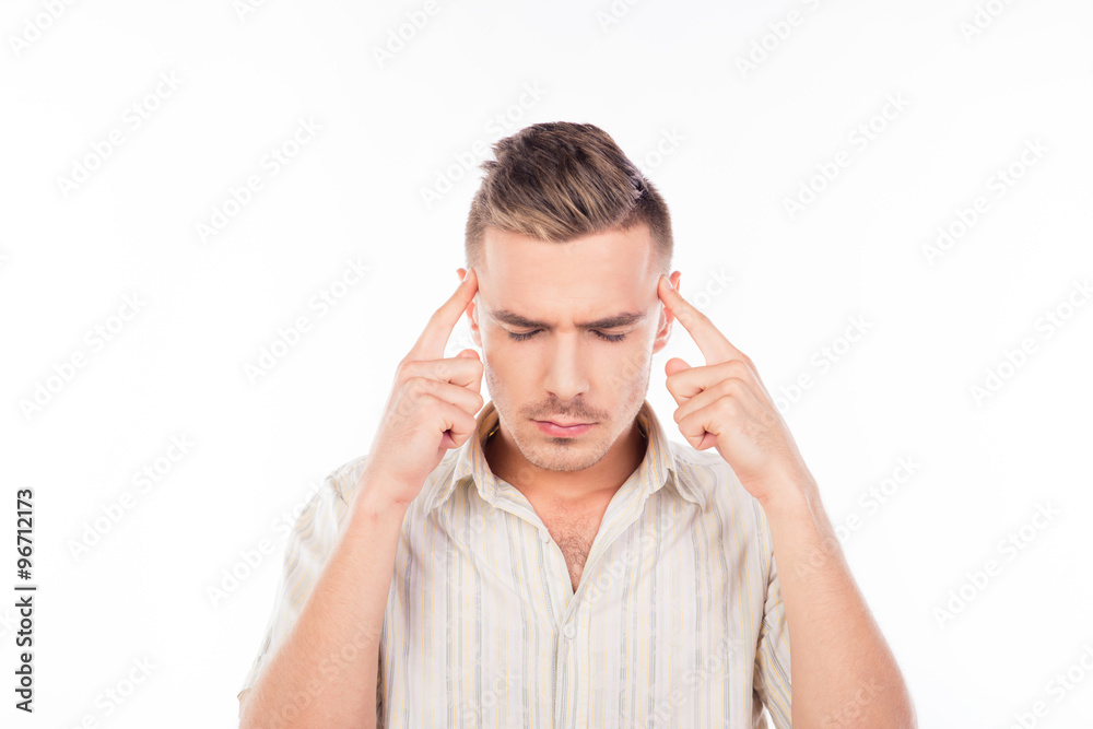 Handsome young man touching his head feeling strong headache Handsome young man touching his head feeling strong headache