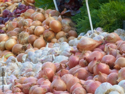 Various varieties of onion and garlic at farmers' market