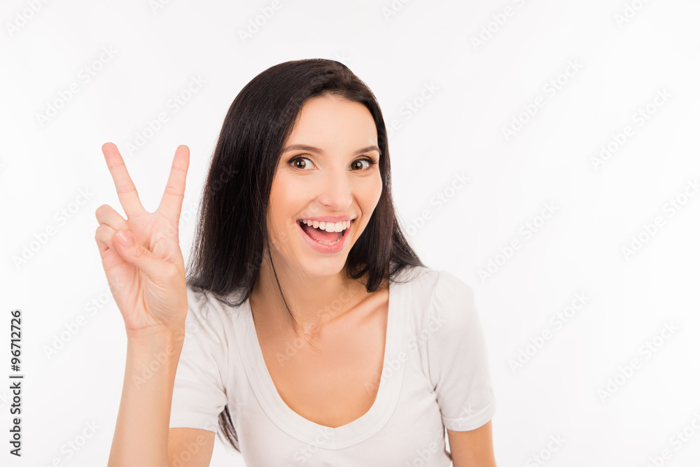 Cheerful funny cute girl gesturing two fingers Cheerful funny cute girl gesturing two fingers