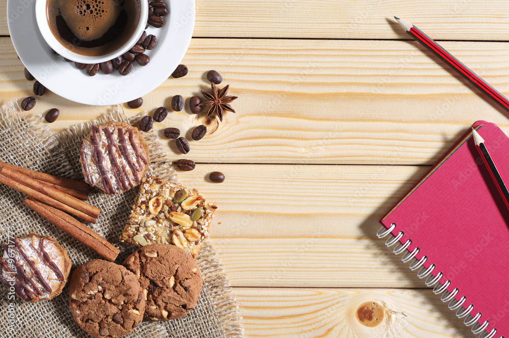 Fototapeta premium Cookies, coffee and notepad on a table