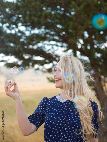 Woman blowing bubbles