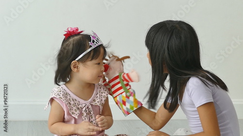 Young girl playing with hand puppet