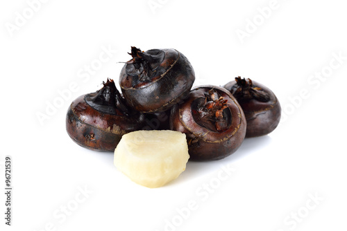 whole and peeled Chinese water chestnut or waternut on white bac