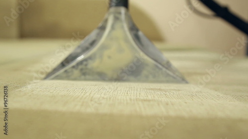 Service cleaning dirty sofa and chairs with special tool, the detergent is applied, operation of the wet and dry vacuum cleaner

