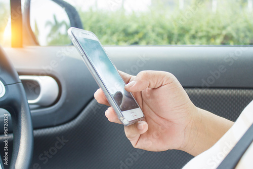  man using phone while driving the car