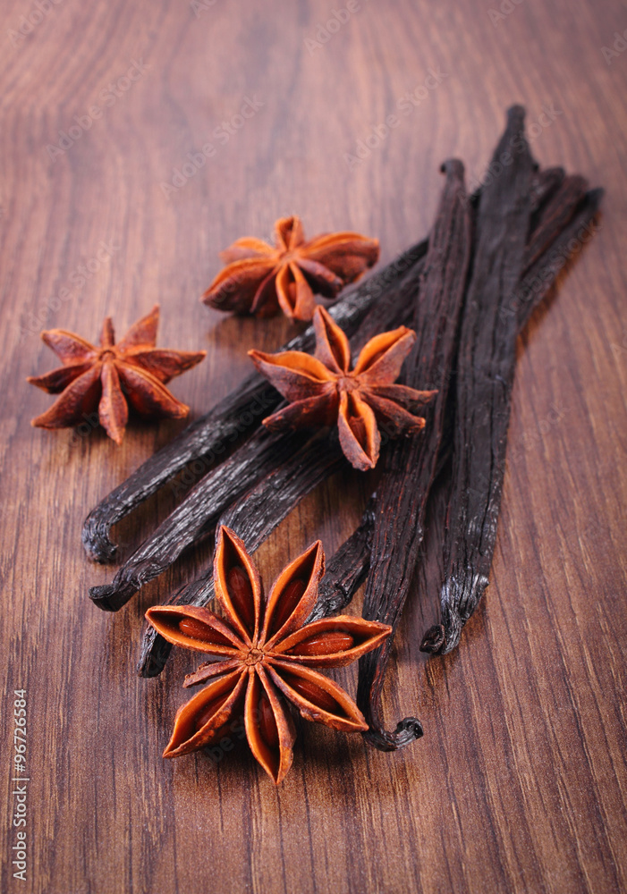 Fragrant vanilla and star anise on wooden surface plank Fragrant vanilla and star anise on wooden surface plank