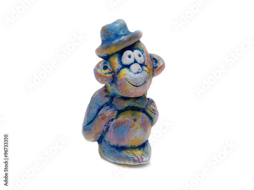 merry monkey in blue bowler hat from clay pottery isolated on white