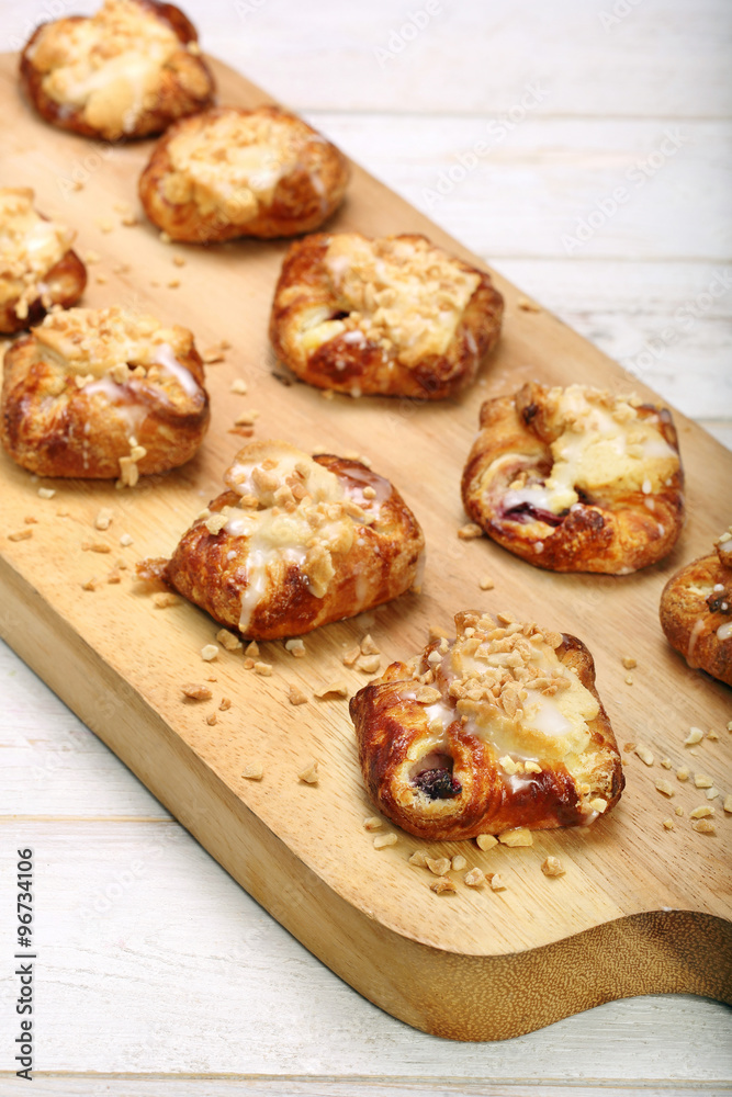 Croissant stuffed jam with walnuts on wooden background Croissant stuffed jam with walnuts on wooden background