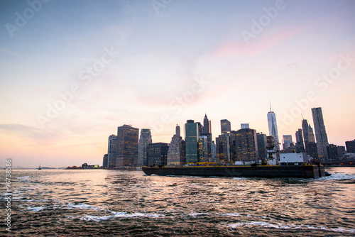 tanker in front of new-york city during the sunset