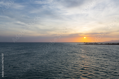 Colorful ocean beach sunset with deep blue sky and sun rays on the harbor of Margarita  Venezuela.