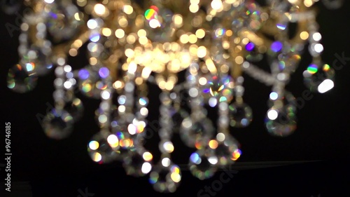 Crystal chandelier on black background. Crystals sway and sparkle. 