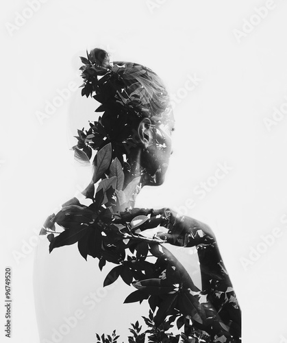 Creative double exposure portrait of attractive girl with branches of tree