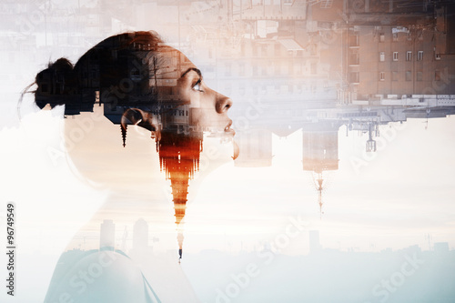Creative double exposure portrait of attractive woman with city