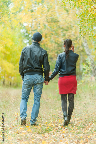 Affectionate couple taking walk in autumn park
