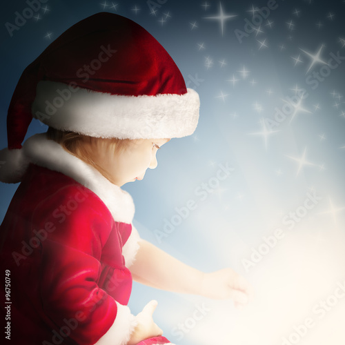 Christmas Child Open Gift on Background with Sparkle and Glitter photo