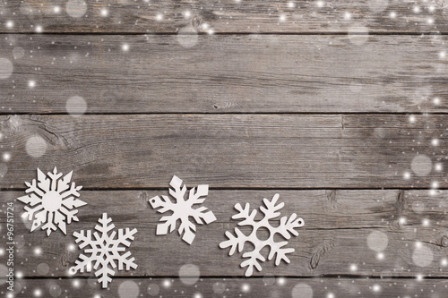 Snowflakes on grunge wooden background