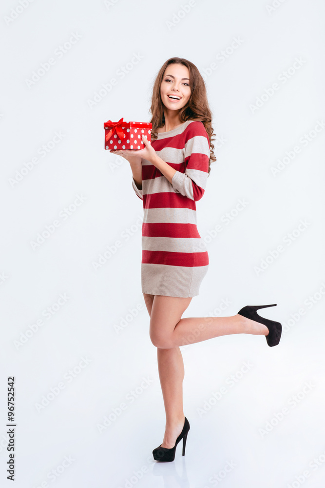 Smiling woman in dress holding gift box Smiling woman in dress holding gift box