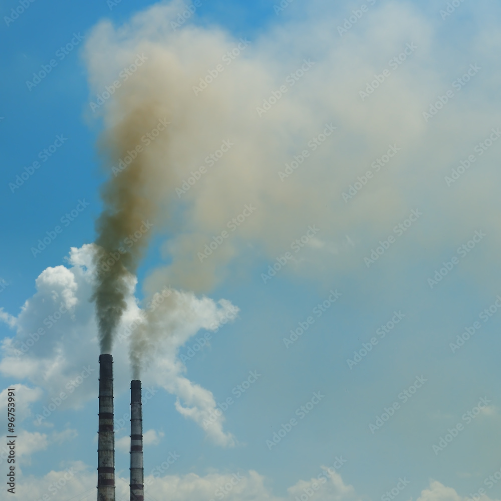 smoke from the pipes against the blue sky