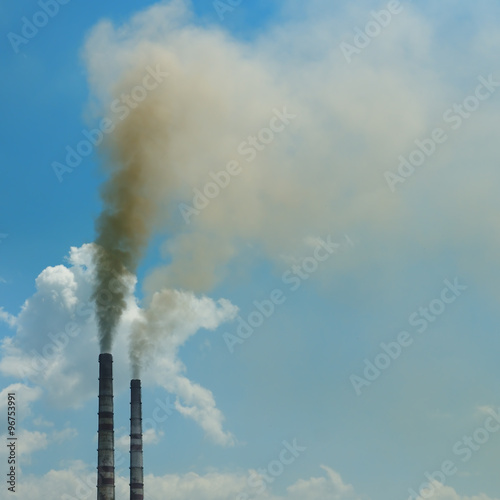 smoke from the pipes against the blue sky