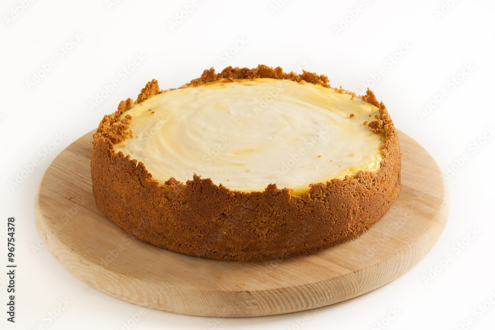 Cheesecake whole on a white background Cheesecake whole on a white background