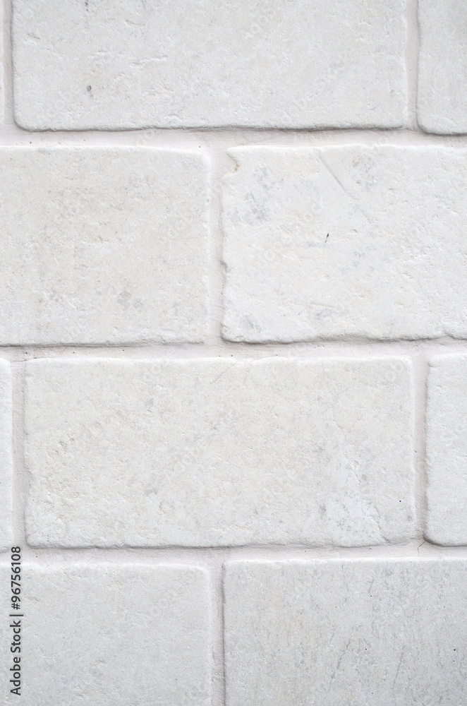 Decorative white cladding slabs imitating stones on wall Decorative white cladding slabs imitating stones on wall