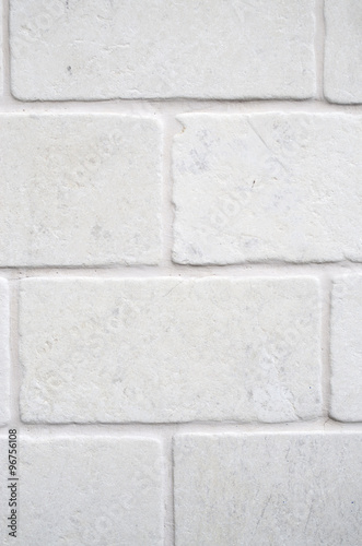 Decorative white cladding slabs imitating stones on wall