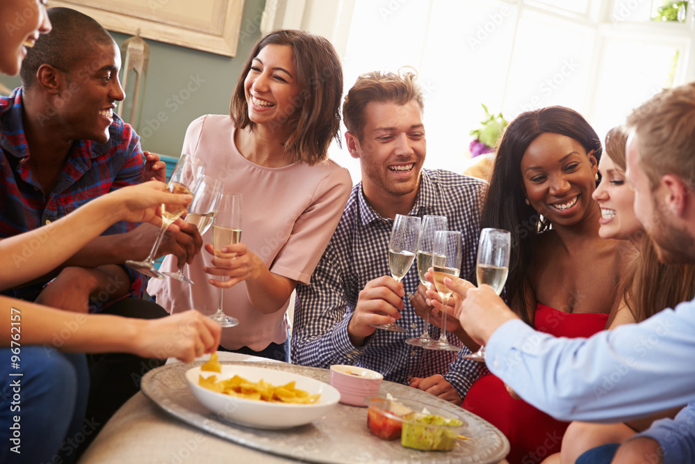 Group Of Friends Celebrating With A Toast At Home