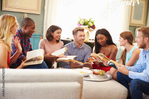 Group Of Friends Taking Part In Book Club At Home photo