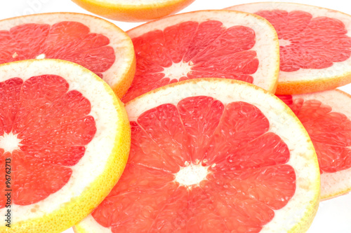 Fresh grapefruit rings on white background