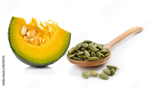 pumpkin seeds in the spoon on white background
