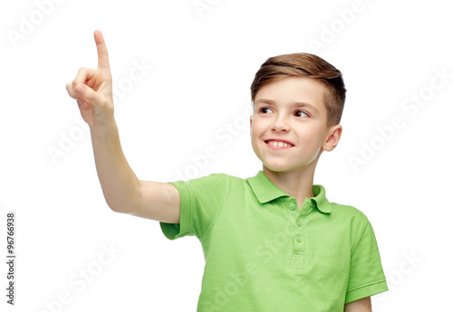 happy boy in green polo t-shirt pointing finger up