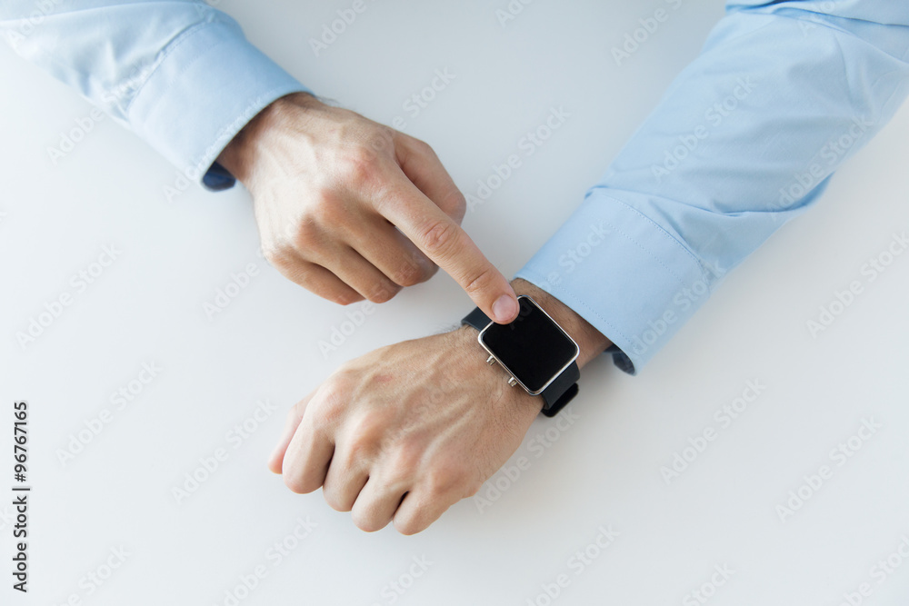 close up of male hands setting smart watch