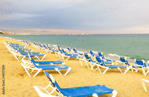 deckchairs on a pebbled beach © Toniflap