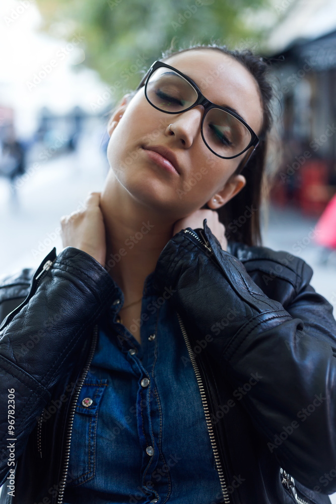 Beautiful young woman with neck pain in the street. Beautiful young woman with neck pain in the street.