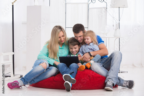 happy family uses a tablet