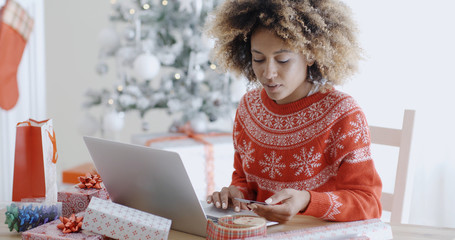 Young woman doing Xmas shopping online