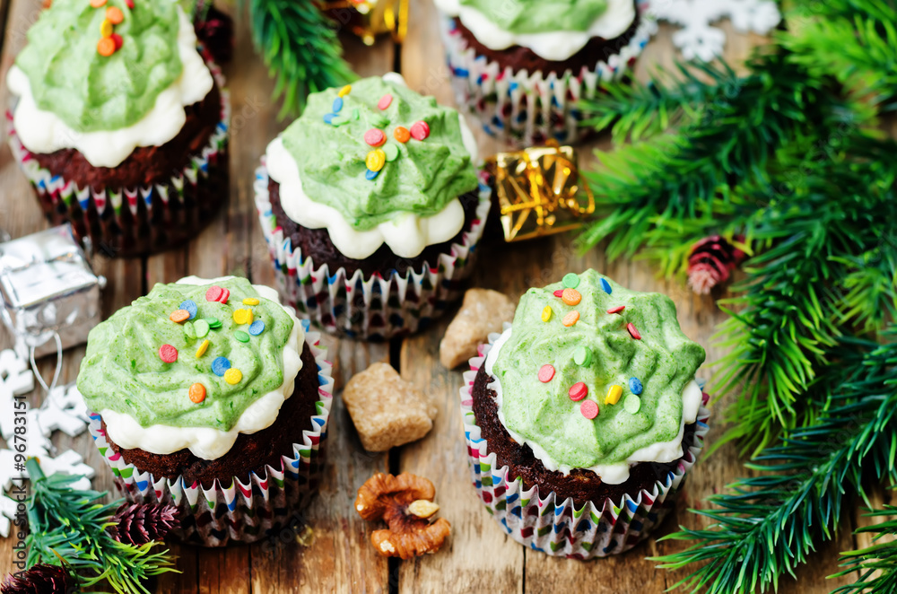 Chocolate cupcakes with green frosting and sprinkles on holiday