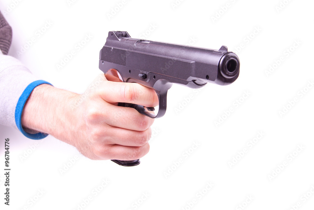 Man's hand holding gun, isolated on white.