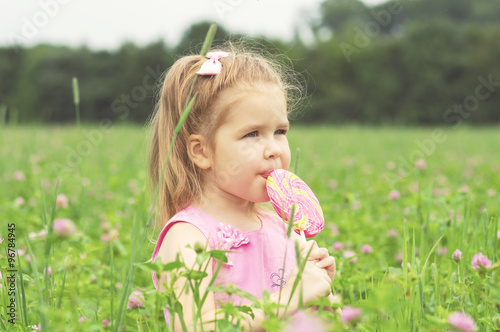  little girl eating a lollipop © Alekss