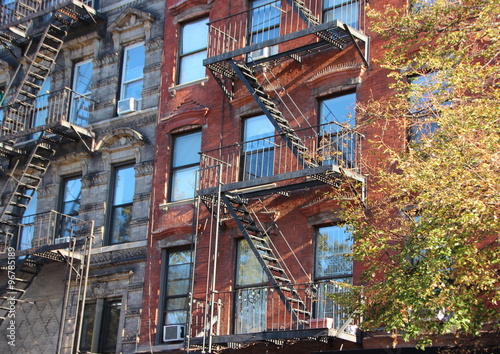 Perspective of Fire Escape Ladders on Apartment Building Block © chrisrt