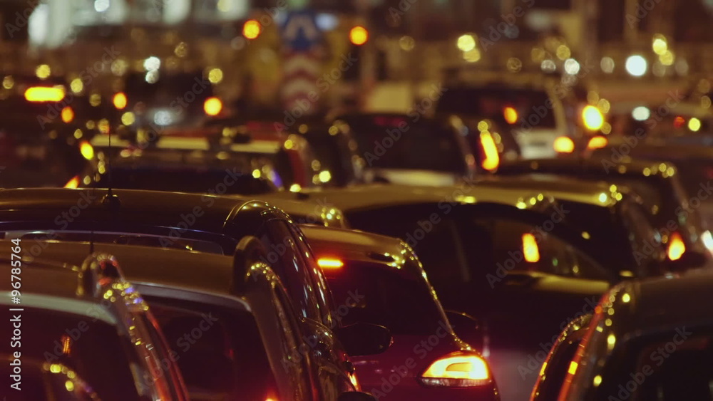 Night traffic jam at city telephoto lens cars grind to a halt on avenue