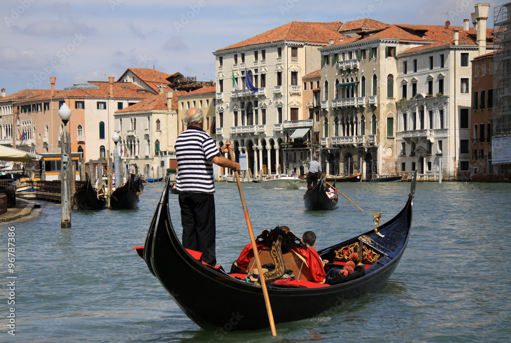 VENICE, ITALY - SEPTEMBER 02, 2012:  Gondolier rides gondola on Grand Canal in Venice - obrazy, fototapety, plakaty 