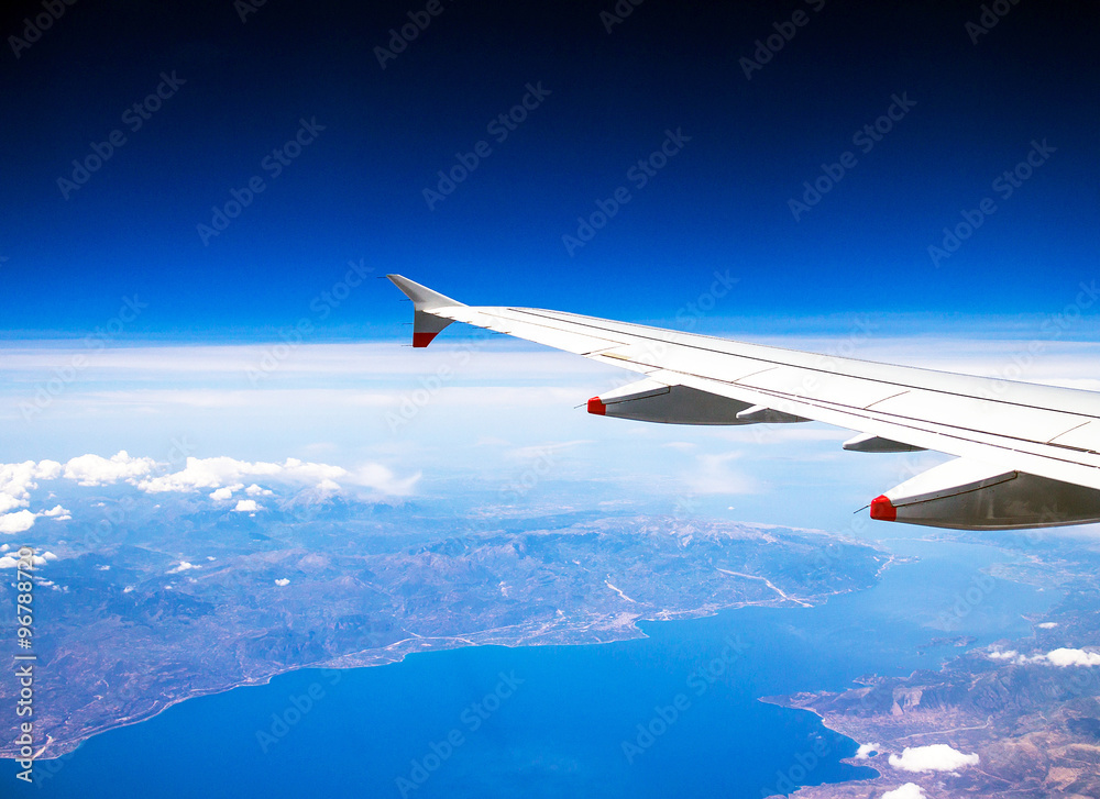 Fototapeta premium Flight Over Rhodes on deep blue sky background with soft focus