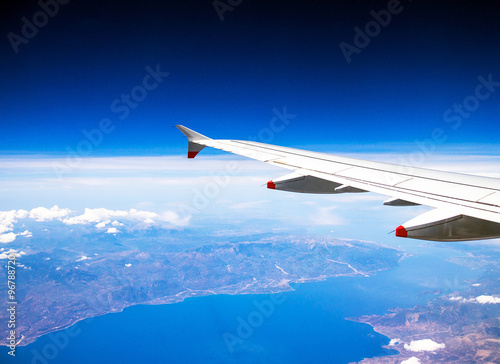 Flight Over Rhodes on deep blue sky background with soft focus